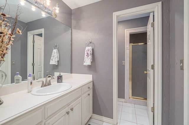 full bathroom with tile patterned flooring, a shower stall, vanity, and baseboards