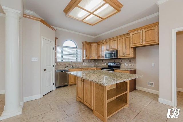 kitchen featuring decorative backsplash, light stone countertops, appliances with stainless steel finishes, and a kitchen island