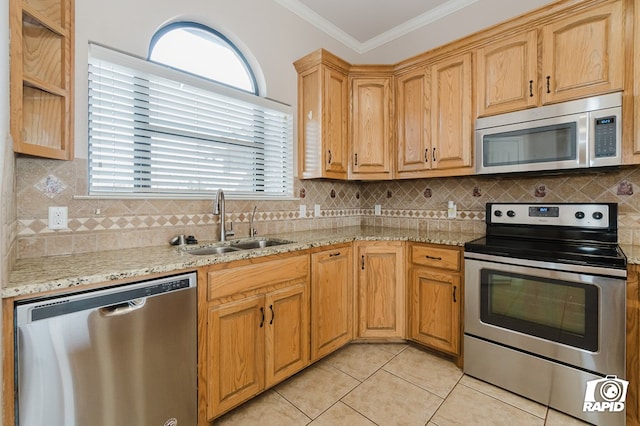 kitchen featuring ornamental molding, a sink, appliances with stainless steel finishes, light tile patterned floors, and decorative backsplash