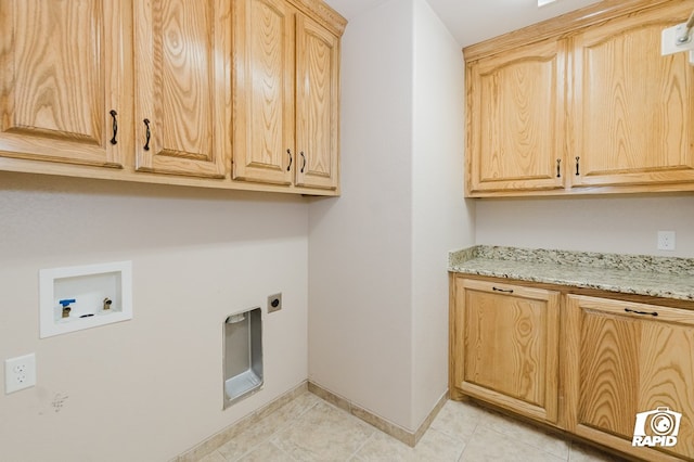 washroom with baseboards, washer hookup, light tile patterned floors, cabinet space, and hookup for an electric dryer