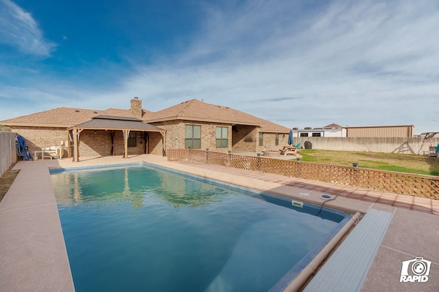 view of pool with a fenced backyard, a fenced in pool, a lawn, and a patio