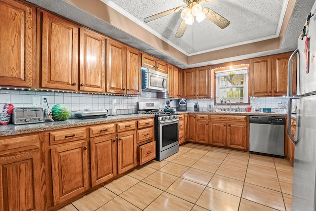 3804 Cedar Spg, Midland, TX 79703 - kitchen with brown cabinets, stainless steel appliances, ornamental molding, backsplash, and a textured ceiling