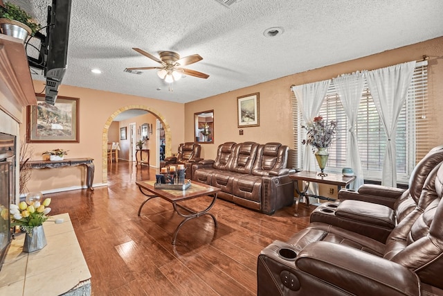 3804 Cedar Spg, Midland, TX 79703 - living area with arched walkways, a ceiling fan, a textured ceiling, and wood finished floors