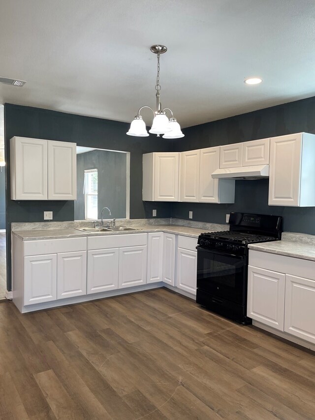 1208 W Tennessee Ave, Midland, TX 79701 - kitchen featuring gas stove, a sink, under cabinet range hood, white cabinetry, and light countertops