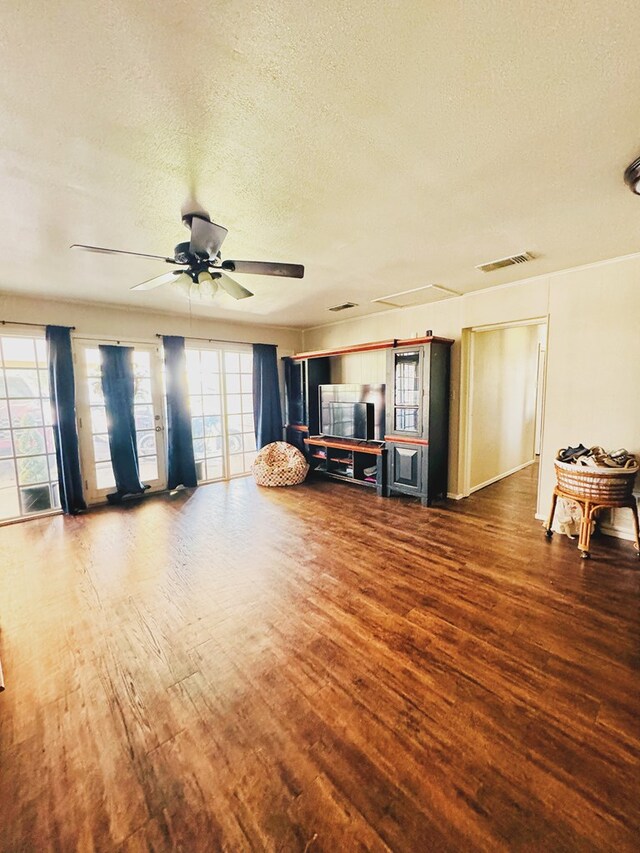 miscellaneous room with ceiling fan, hardwood / wood-style floors, and a textured ceiling