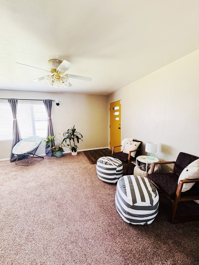 living area featuring carpet and ceiling fan