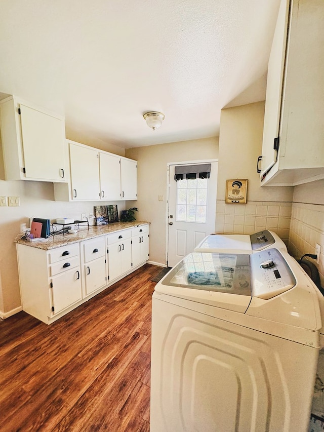 washroom with dark hardwood / wood-style flooring and washer and clothes dryer