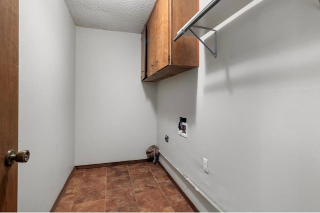 laundry room featuring a textured ceiling, cabinets, hookup for a washing machine, and electric dryer hookup