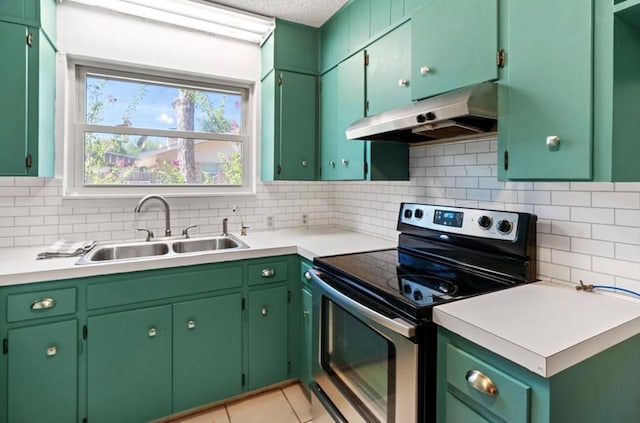 kitchen featuring green cabinetry, backsplash, electric range, and sink