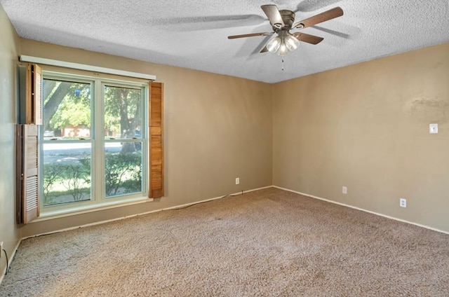 spare room featuring ceiling fan, a textured ceiling, and carpet flooring