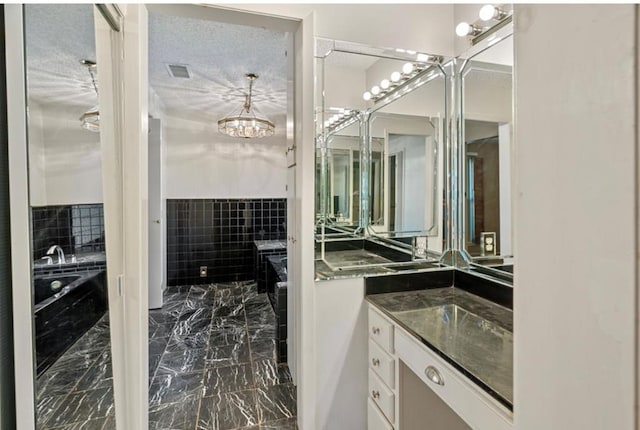 bathroom featuring vanity and a textured ceiling