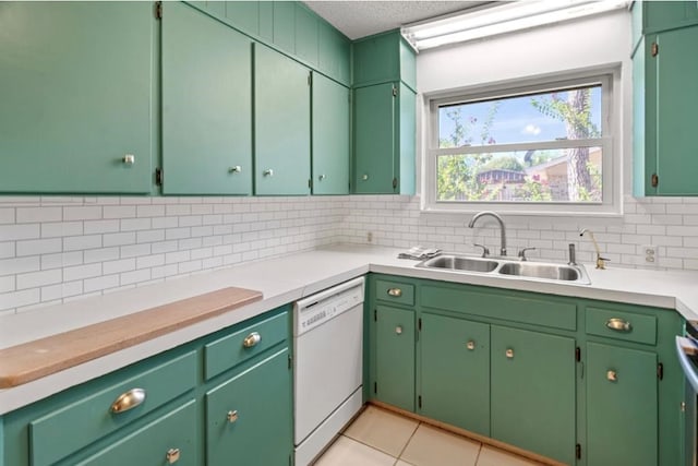 kitchen featuring light tile patterned floors, decorative backsplash, white dishwasher, and sink