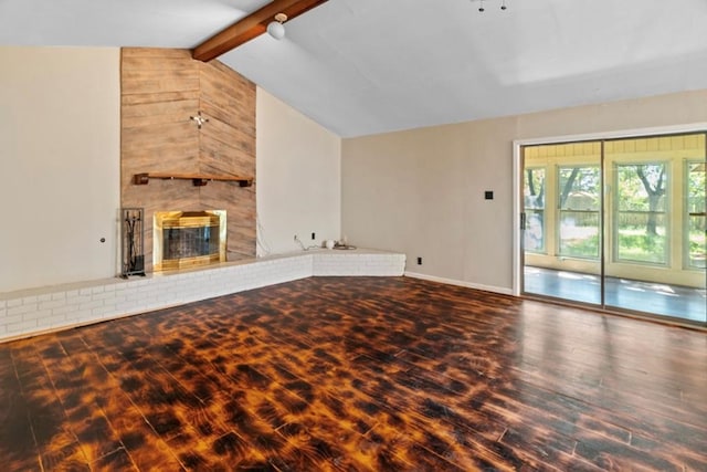 unfurnished living room with vaulted ceiling with beams, a fireplace, and hardwood / wood-style floors