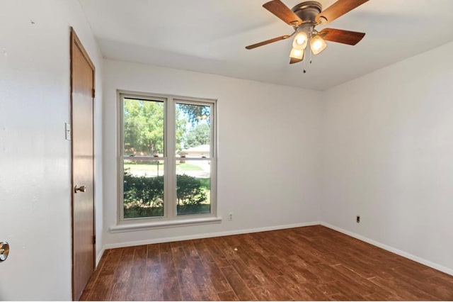 empty room with ceiling fan and dark hardwood / wood-style flooring