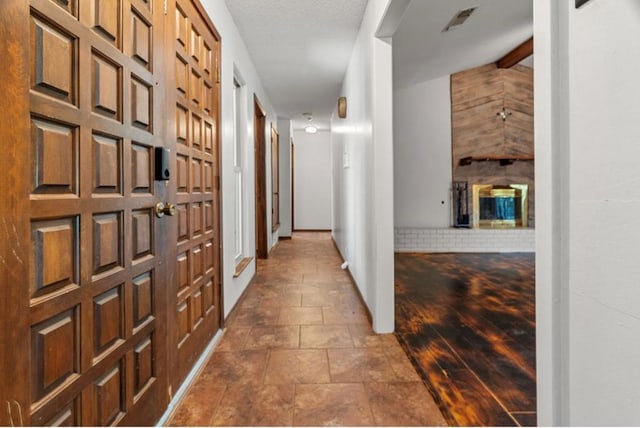 corridor with a textured ceiling