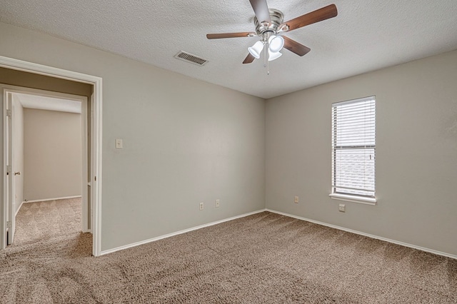 3205 Dentcrest Dr Unit B, Midland, TX 79707 - carpeted spare room with ceiling fan, a textured ceiling, and baseboards