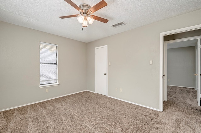3205 Dentcrest Dr Unit B, Midland, TX 79707 - unfurnished bedroom with carpet flooring, baseboards, a textured ceiling, and a ceiling fan