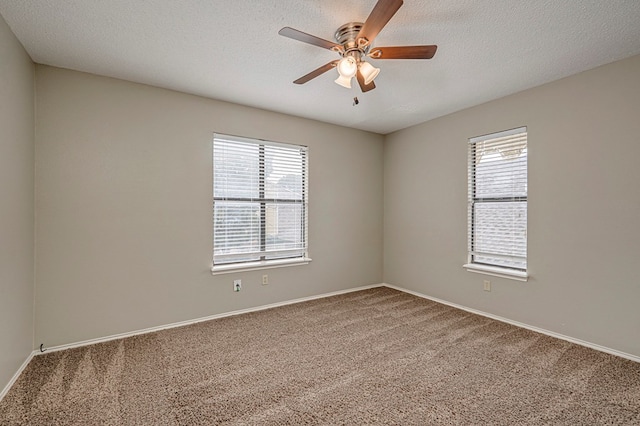 3205 Dentcrest Dr Unit B, Midland, TX 79707 - unfurnished room with carpet floors, plenty of natural light, a ceiling fan, a textured ceiling, and baseboards