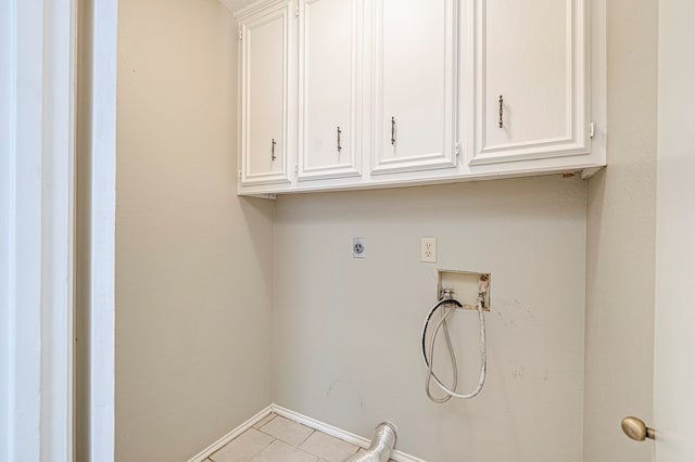3205 Dentcrest Dr Unit B, Midland, TX 79707 - washroom with cabinet space, washer hookup, electric dryer hookup, tile patterned floors, and baseboards