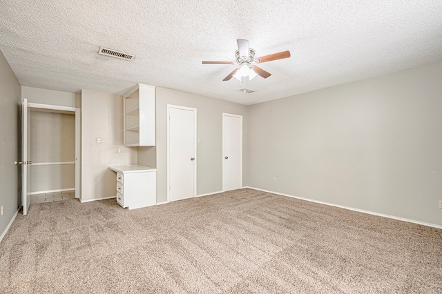 3205 Dentcrest Dr Unit B, Midland, TX 79707 - unfurnished bedroom with light carpet, a textured ceiling, ceiling fan, and baseboards