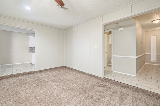 3205 Dentcrest Dr Unit B, Midland, TX 79707 - tiled empty room featuring a textured ceiling and carpet floors