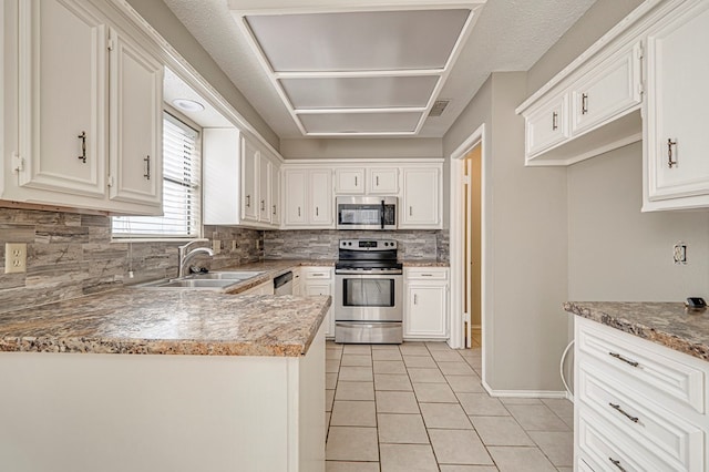 3205 Dentcrest Dr Unit B, Midland, TX 79707 - kitchen featuring stainless steel appliances, a sink, backsplash, light tile patterned floors, and white cabinets