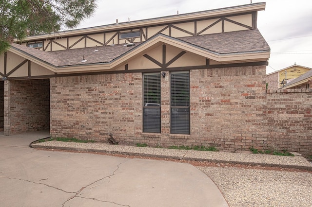 3205 Dentcrest Dr Unit B, Midland, TX 79707 - view of property exterior with brick siding, roof with shingles, and stucco siding