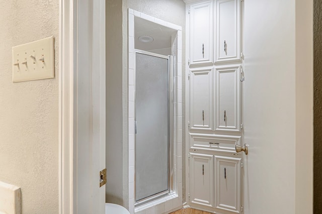 3205 Dentcrest Dr Unit B, Midland, TX 79707 - full bathroom with a stall shower, a textured wall, and toilet
