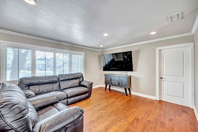 1002 Boyd Ave, Midland, TX 79705 - living room with light wood-type flooring, ornamental molding, baseboards, a textured ceiling, and visible vents