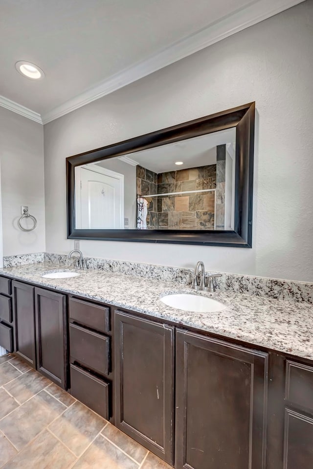 1002 Boyd Ave, Midland, TX 79705 - full bath with double vanity, a sink, crown molding, and a tile shower