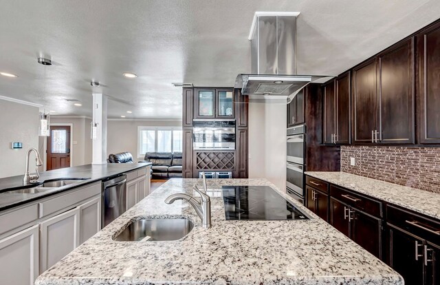 1002 Boyd Ave, Midland, TX 79705 - kitchen with island range hood, tasteful backsplash, a sink, and stainless steel appliances