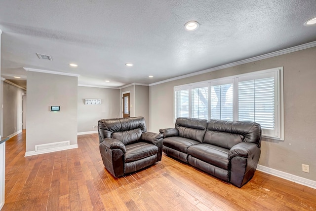 1002 Boyd Ave, Midland, TX 79705 - living area featuring light wood-style flooring, crown molding, baseboards, and visible vents