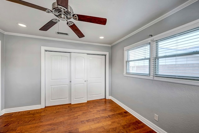 1002 Boyd Ave, Midland, TX 79705 - unfurnished bedroom featuring baseboards, visible vents, wood finished floors, and ornamental molding