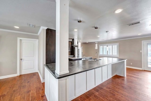 1002 Boyd Ave, Midland, TX 79705 - kitchen featuring dark wood-style flooring, a sink, crown molding, and visible vents