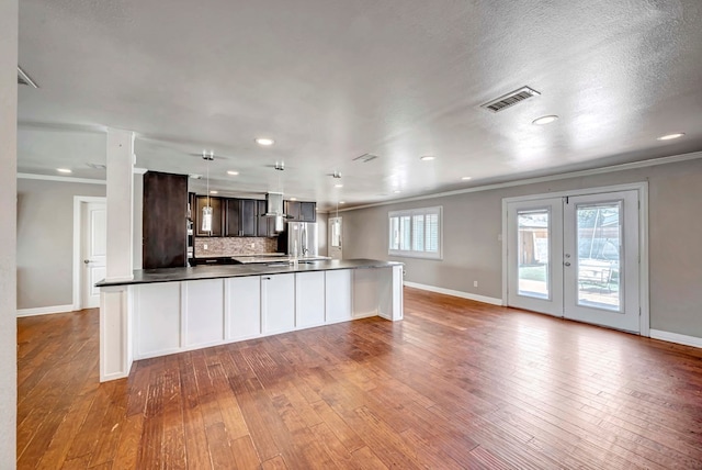 1002 Boyd Ave, Midland, TX 79705 - kitchen featuring freestanding refrigerator, hardwood / wood-style floors, crown molding, and visible vents