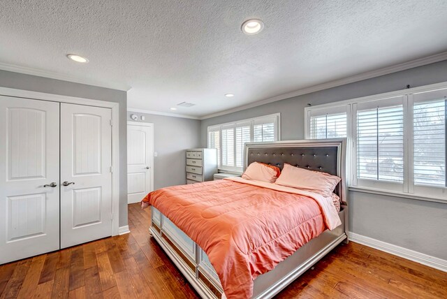 1002 Boyd Ave, Midland, TX 79705 - bedroom with hardwood / wood-style floors, ornamental molding, baseboards, a textured ceiling, and a closet