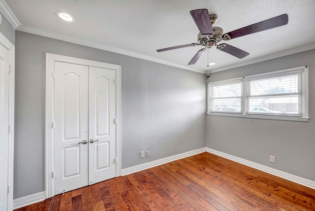 1002 Boyd Ave, Midland, TX 79705 - unfurnished bedroom featuring a closet, a ceiling fan, baseboards, ornamental molding, and hardwood / wood-style floors
