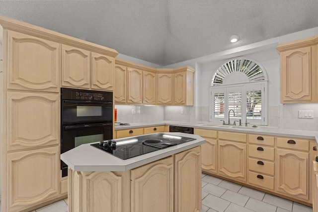 kitchen with tasteful backsplash, light brown cabinetry, light countertops, black appliances, and a sink