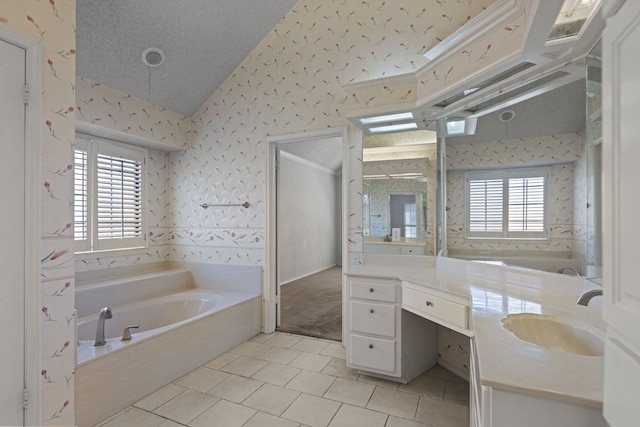 bathroom with a healthy amount of sunlight, a textured ceiling, wallpapered walls, and lofted ceiling