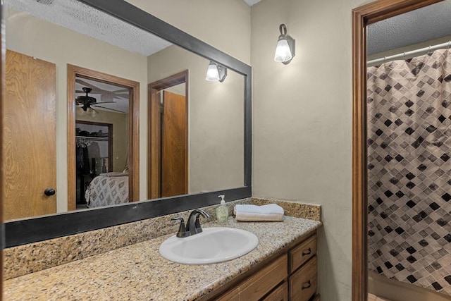 bathroom featuring vanity, a textured ceiling, and a shower with shower curtain