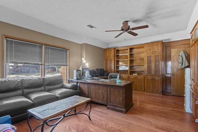 office with ceiling fan, hardwood / wood-style floors, and a textured ceiling