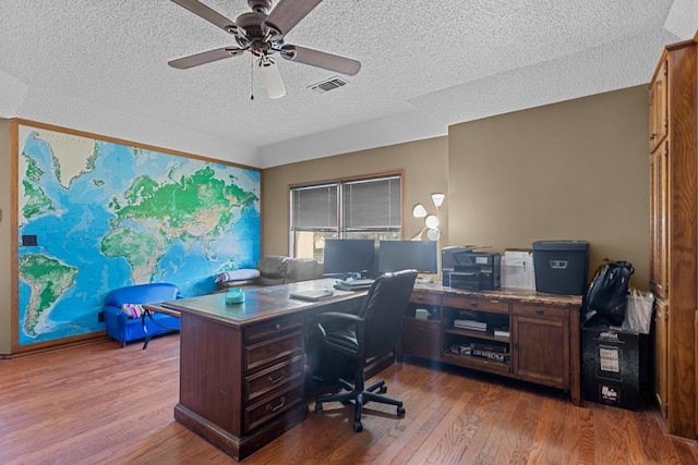 office featuring ceiling fan, a textured ceiling, and dark hardwood / wood-style flooring