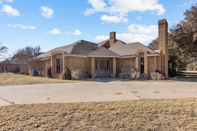 ranch-style house with central AC unit