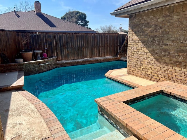 view of swimming pool featuring an in ground hot tub