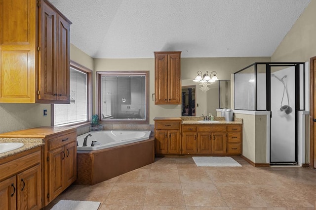 bathroom featuring vaulted ceiling, plus walk in shower, vanity, tile patterned floors, and a textured ceiling