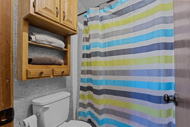 bathroom with toilet and a shower with shower curtain