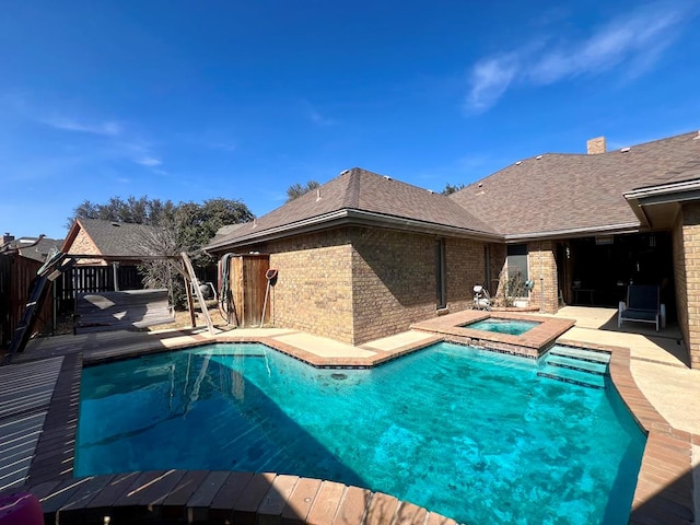 view of swimming pool featuring an in ground hot tub