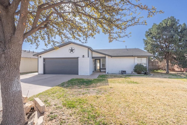 single story home featuring fence, concrete driveway, a front lawn, a garage, and brick siding