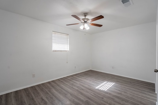 unfurnished room with a ceiling fan, baseboards, visible vents, and dark wood-style flooring