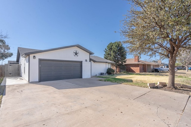 ranch-style house with brick siding, driveway, an attached garage, and fence